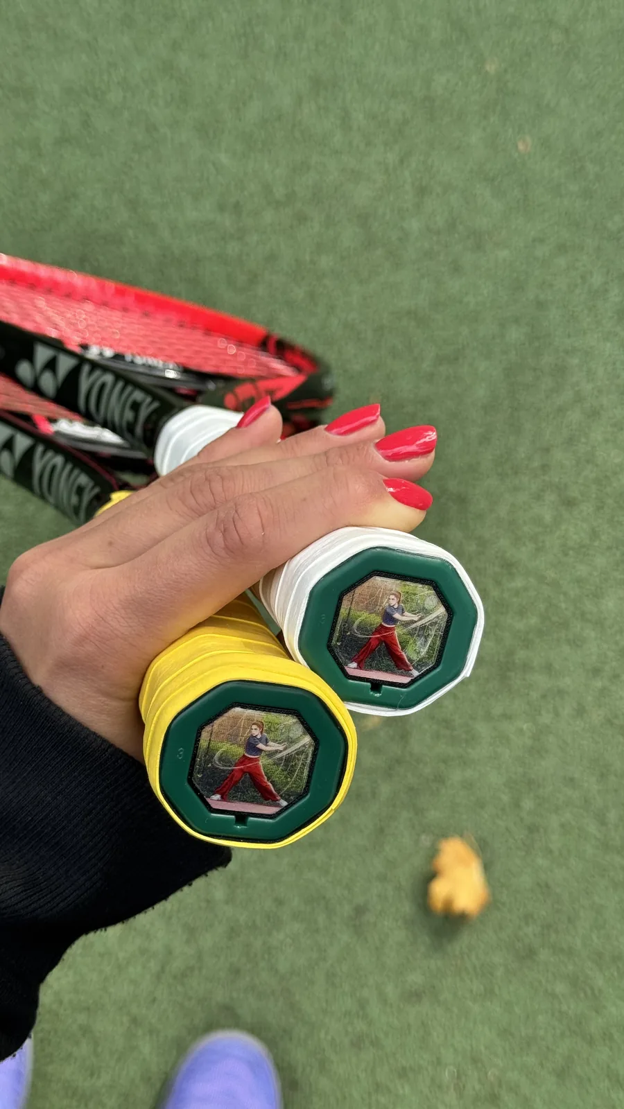 Two Yonex rackets with custom photo Trapdoors in the handles