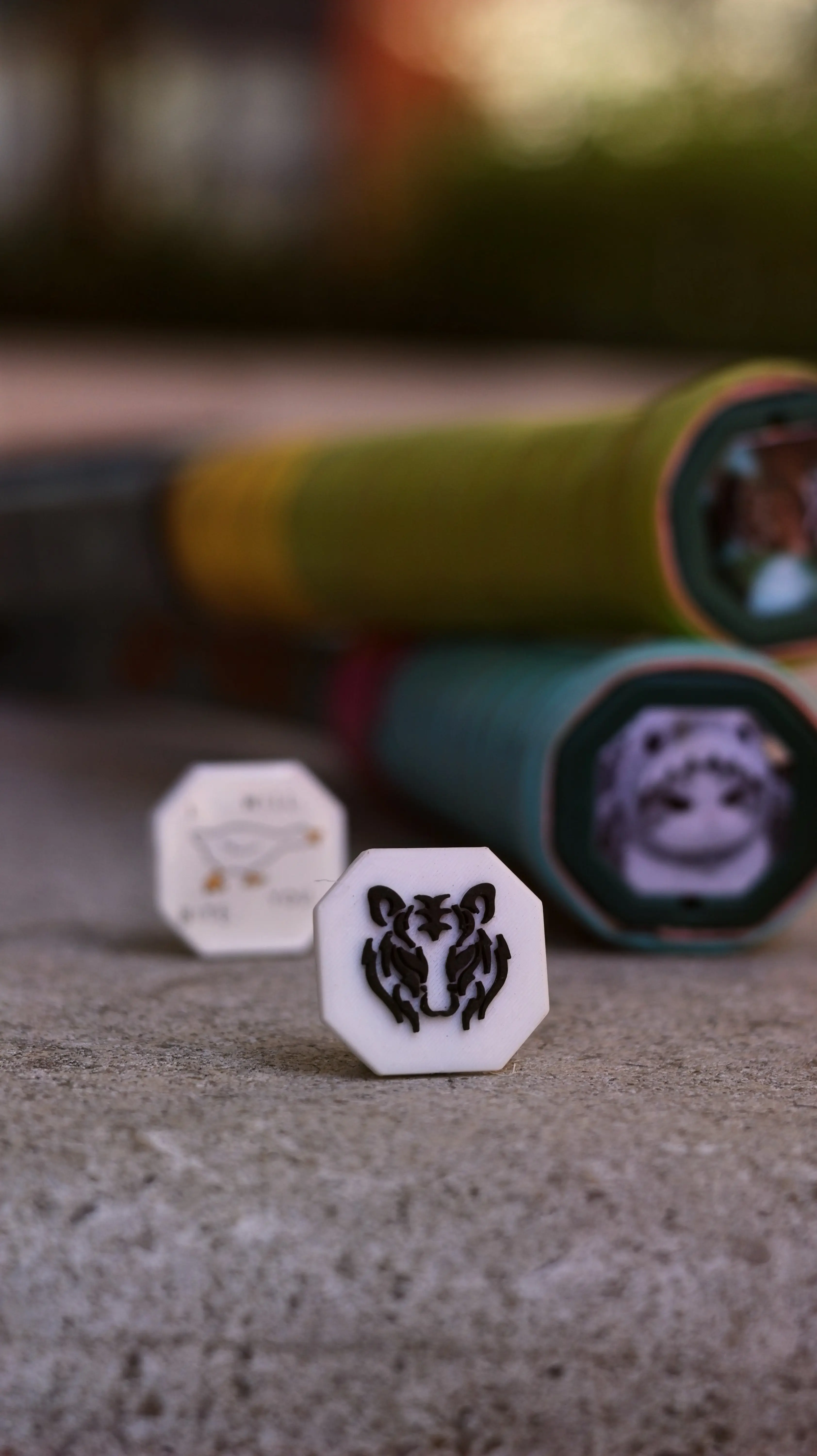 A white tiger-design Trapdoor in focus, with racket handles fitted with photo Trapdoors behind it